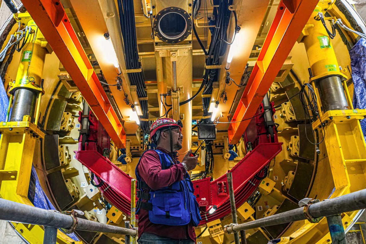 Engineer controlling a tunnel boring machine at a construction site in Jakarta, Indonesia.